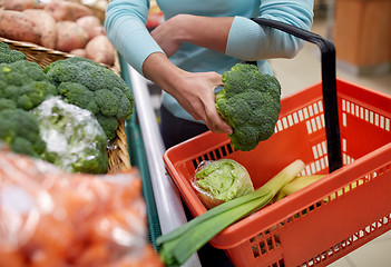 Image showing woman with basket buying broccoli at grocery store