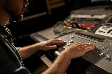 Image showing man using mixing console in music recording studio