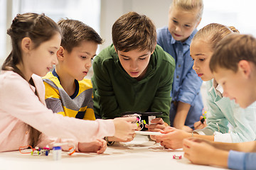 Image showing happy children building robots at robotics school