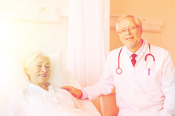 Image showing doctor visiting senior woman at hospital ward