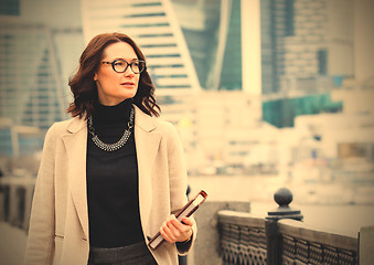 Image showing portrait of a beautiful middle-aged woman with books in hand