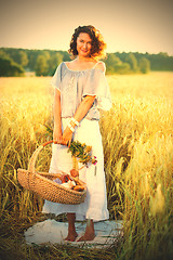 Image showing Beautiful middle-aged woman standing in a wheat field