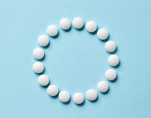 Image showing white pills on blue background