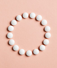 Image showing white pills on pink background