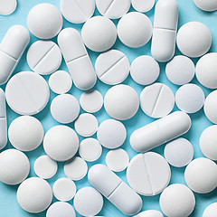 Image showing white pills on blue background