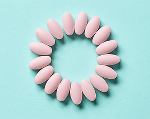 Image showing pink pills on blue background