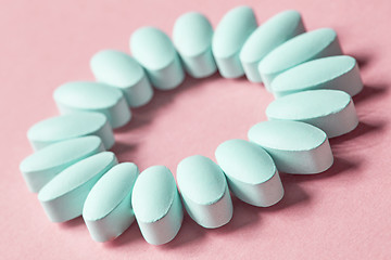 Image showing blue pills on pink background