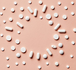 Image showing white pills on pink background