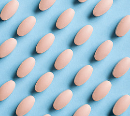 Image showing pink pills on blue background