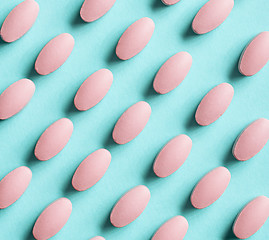 Image showing pink pills on blue background