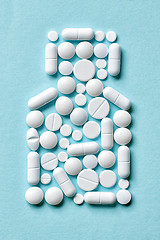 Image showing white pills on blue background