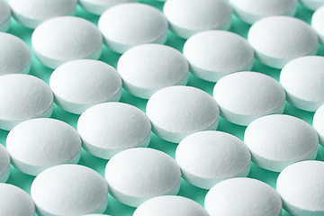 Image showing white pills on blue background