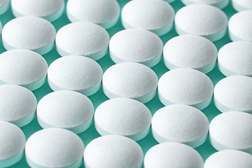 Image showing white pills on blue background