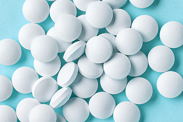 Image showing white pills on blue background