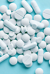 Image showing white pills on blue background