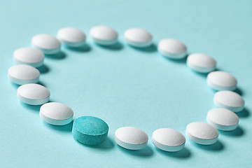 Image showing white pills on blue background