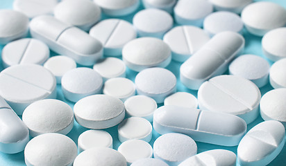 Image showing white pills on blue background