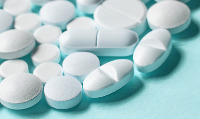 Image showing white pills on blue background