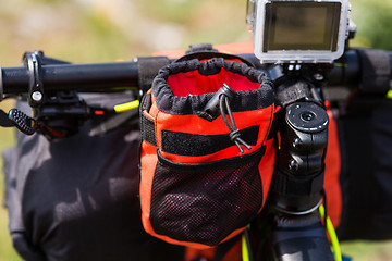 Image showing Bicycle with orange bags for travel