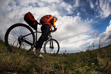 Image showing Young man is riding bicycle outside. Healthy Lifestyle.