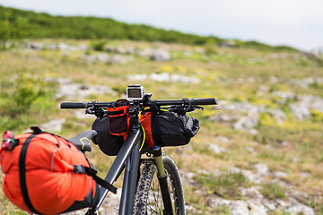 Image showing Bicycle with orange bags for travel