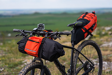 Image showing Bicycle with orange bags for travel