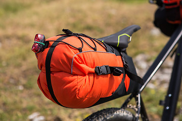 Image showing Bicycle with orange bags for travel