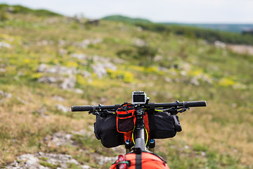 Image showing Bicycle with orange bags for travel