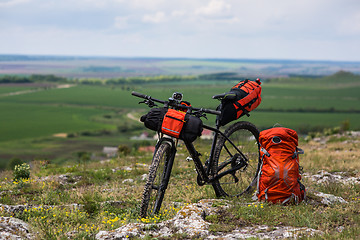 Image showing Bicycle with orange bags for travel