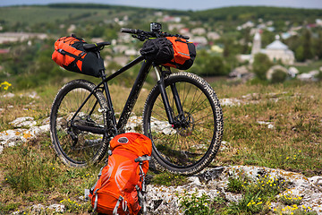 Image showing Bicycle with orange bags for travel