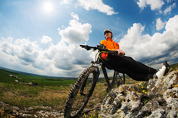 Image showing Young man is riding bicycle outside. Healthy Lifestyle.