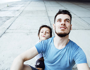 Image showing mature father with his son under the bridge having fun together 