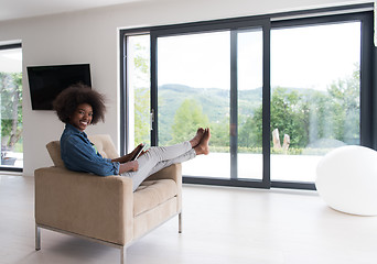 Image showing african american woman at home with digital tablet