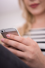 Image showing woman sitting on sofa with mobile phone