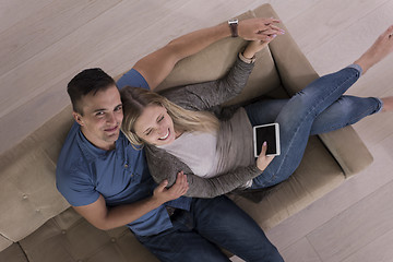 Image showing youg couple in living room with tablet top view