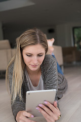 Image showing young women used tablet computer on the floor