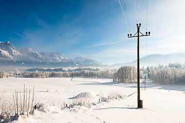 Image showing Austrian Winter Wonderland with mountains, fresh snow and haze in the sunlight