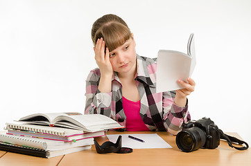 Image showing She tries to learn to photograph a variety of reading manuals and tutorials