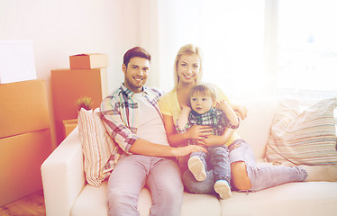 Image showing happy family with boxes moving to new home