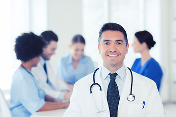 Image showing happy doctor over group of medics at hospital