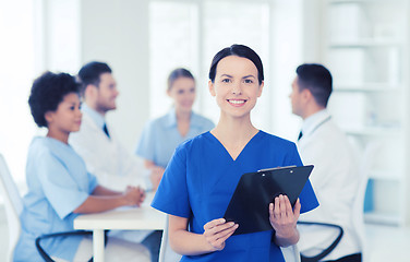 Image showing happy doctor over group of medics at hospital