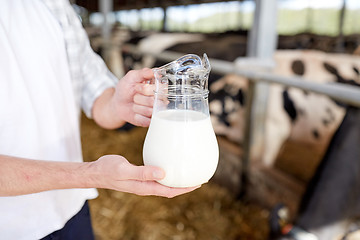 Image showing close up of man or farmer with milk on dairy farm