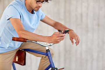 Image showing man with smartphone and fixed gear bike on street