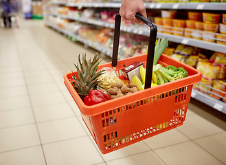 Image showing woman with food basket at grocery or supermarket