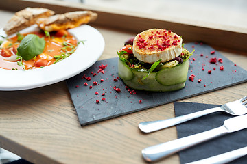 Image showing goat cheese salad and gazpacho soup at restaurant