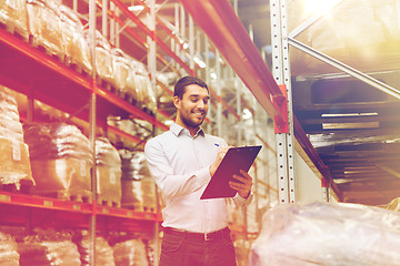 Image showing businessman with clipboard at warehouse