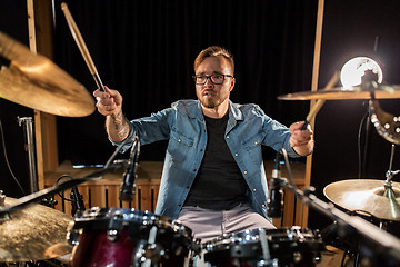 Image showing male musician playing drums and cymbals at concert