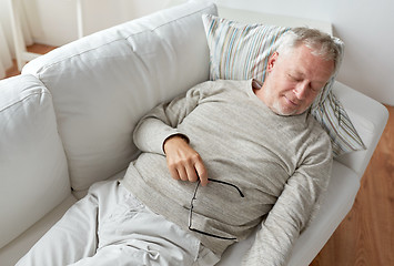 Image showing senior man sleeping on sofa at home