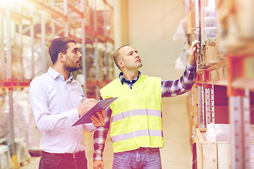 Image showing worker and businessmen with clipboard at warehouse