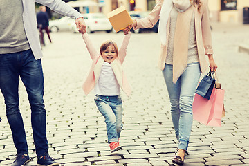 Image showing happy family with child and shopping bags in city